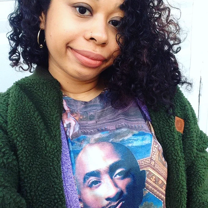 Vanessa Willoughby in a green sweater and Tupac tshirt