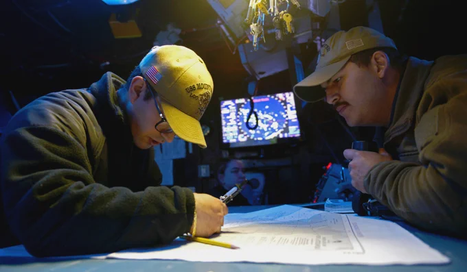 Operations Specialist 3rd Class Antonio Mannino, left, and Operations Specialist 2nd Class Freddy Palacios plot a course in the combat information center aboard USS Mount Whitney (LCC 20) during exercise BALTOPS22. 📸 Mass Communication Specialist 1st Class Jacob Sippel