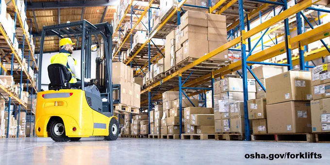 A worker operates a forklift in a warehouse to move boxes. osha.gov/forklifts