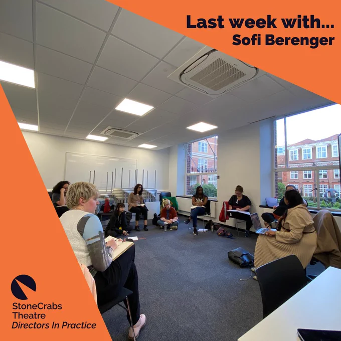 A square which has an orange background with a spotlight shining from the upper left corner which has a photo in it. The photo is of a diverse group of young people sat on chairs which are gathered in a circle around a woman in a classroom. The classroom has cream walls and a grey-blue carpet. Dark indigo text in the upper right corner reads: Last week with...Sofi Berenger.