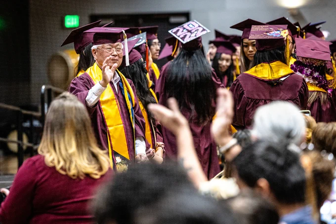 Student waves to family members.