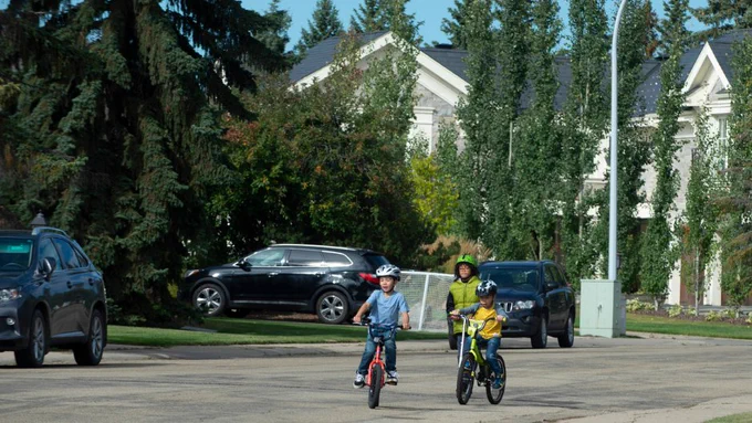 Kids biking and scooting.
