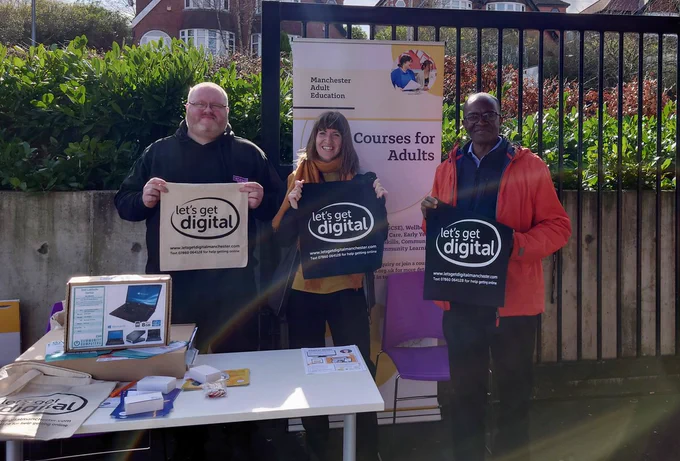 2 men and 1 woman stood with Lets Get Digital promo materials