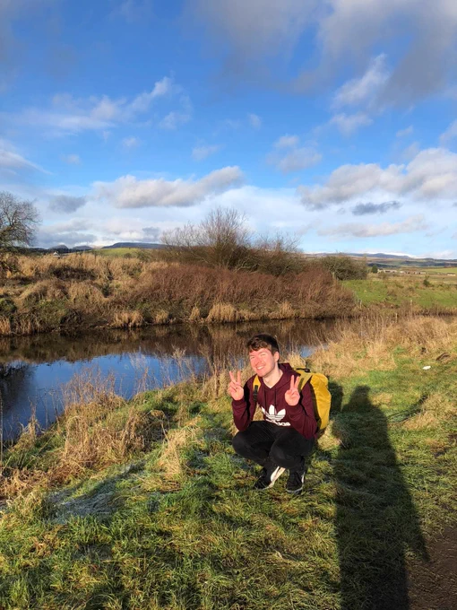 Sam out in nature again, posing close to the ground.