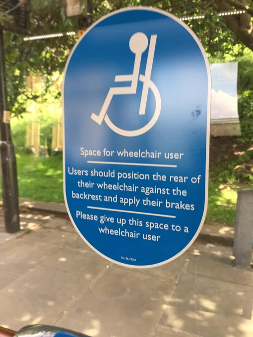 Sign on inside of the bus giving priority to wheelchair users.