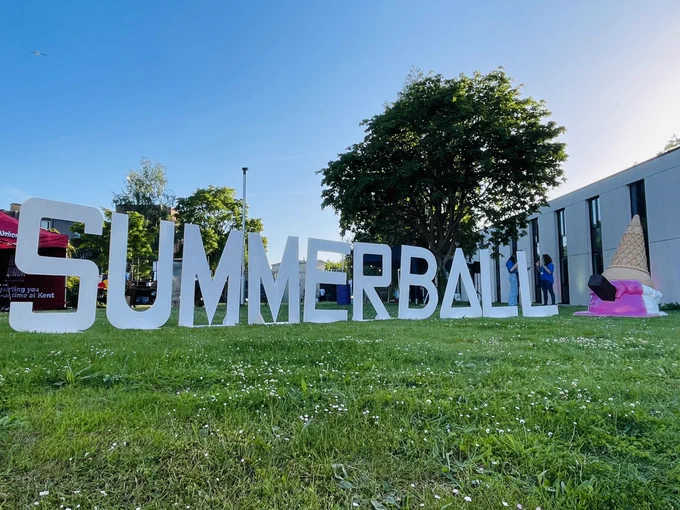 A big letter sign that reads ‘Summer Ball’ with an upside down ice cream sculpture to the right