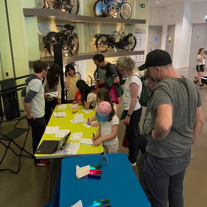 Crowd of people around an activity table