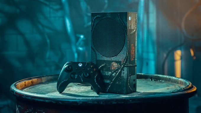 An image of a custom Stranger Things Xbox Series S Console and controller displayed on top of a metallic barrel