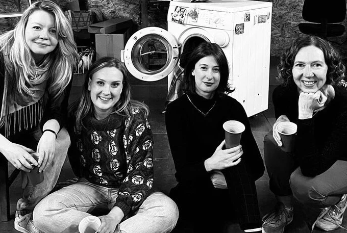 Katherine Newman, Kate Shenton, Sophie Steer and Amanda Hadingue smile at the camera on set with a beer in hand after the last night of the show.