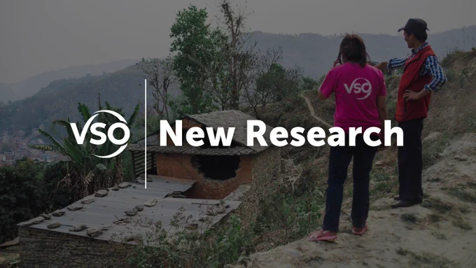 Two people stood on ground looking down at house. Text reading 'New Research'