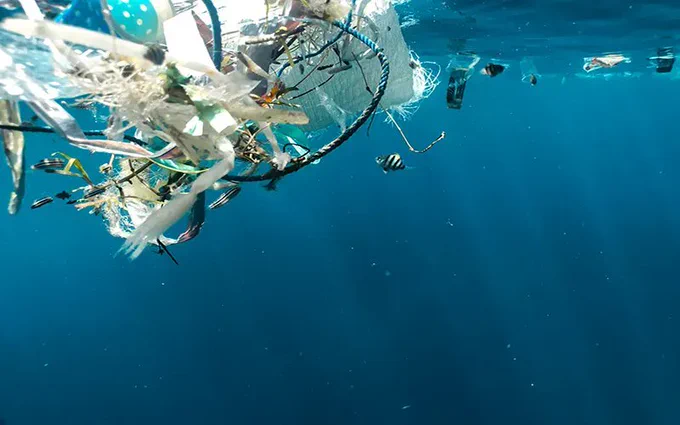 Plastic waste floating in a blue ocean