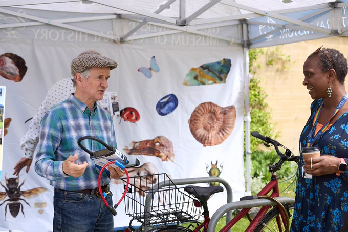 Visitor to Explore Science Together hearing about bike theft safety tips from a volunteer from Oxford Neighbourhood Watch, outside the Oxford Museum of Natural History (credit: Andrew Bailey)