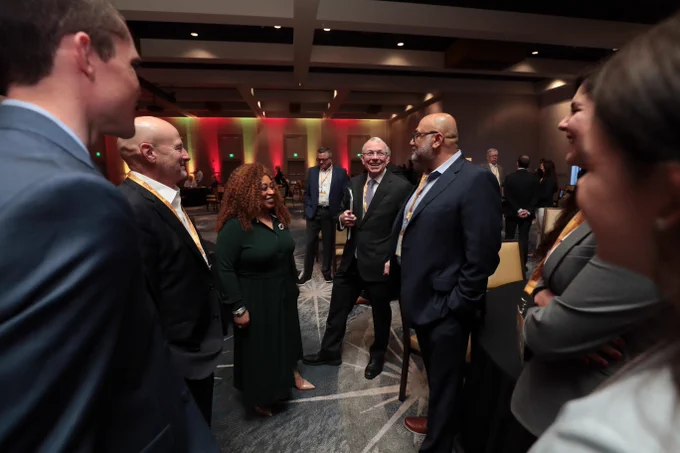 Group of people conversing and smiling