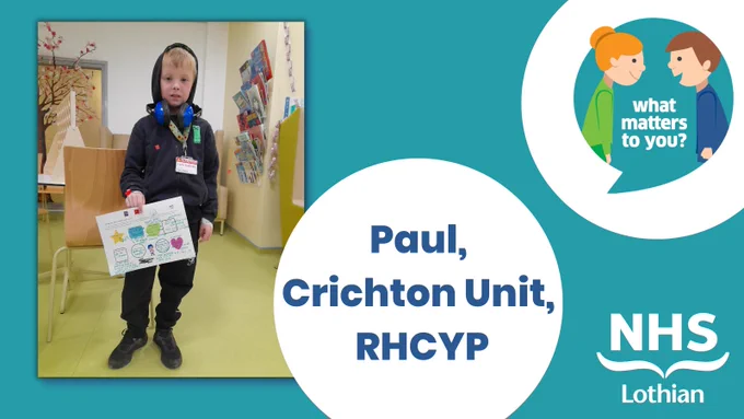 Paul, a young patient at the RHCYP in Edinburgh, standing holding his coloured-in sheet with details about himself.