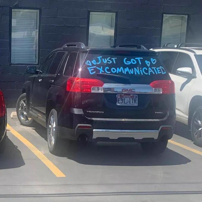 Back of a car that says “just got excommunicated” like a “just got married” message