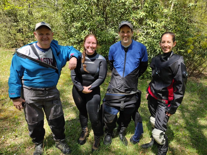 A group photo of two females and two males, the diving team who found and took pictures of the candy darters.