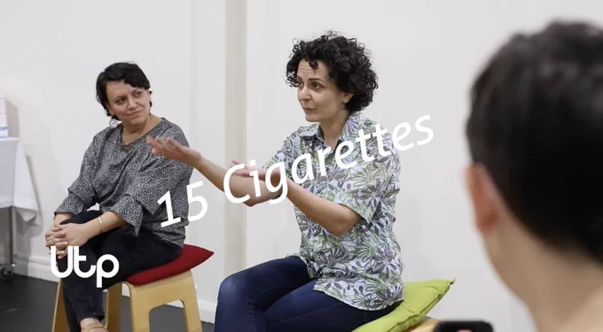 Image of Utp Creative Producer Eddie Abd sitting on a chair gesticulating with her hands with overlaid text that reads '15 Cigarettes' and logo in bottom left corner 'Utp'. 