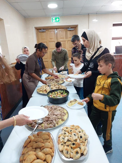 Members of the Migration Team serving food to clients.