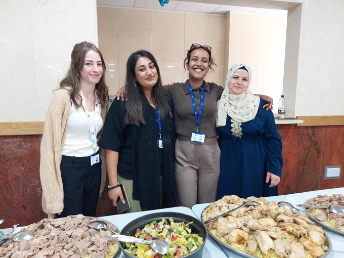 Members of the Migration Team in a group photo with one of the Resettlement Clients. 