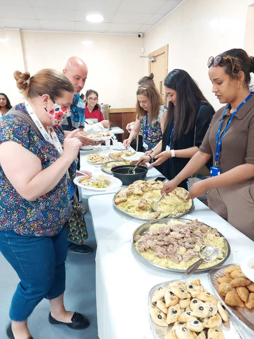 Members of the Migration Team serving food to clients. 