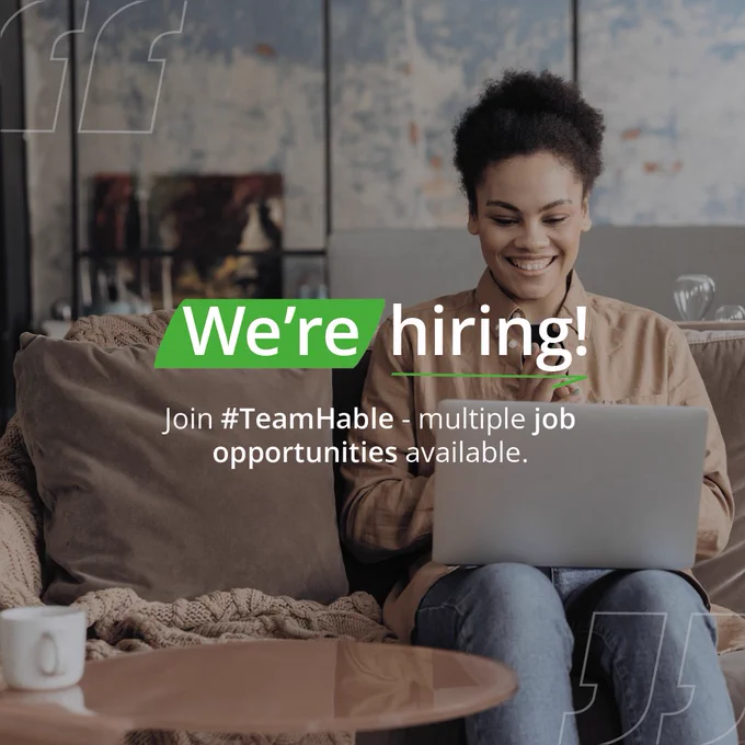 Woman on her sofa smiling at her laptop, with the words "we're hiring" written on top.