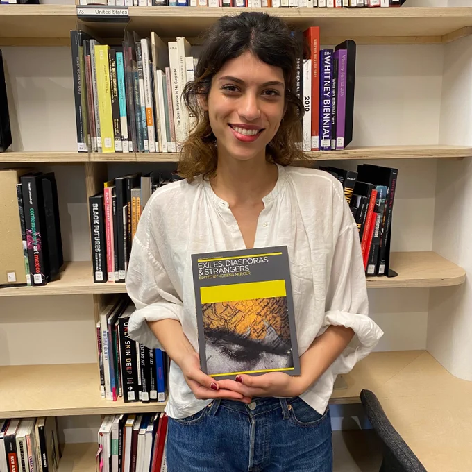 Loulwah Kutbi with iniva's publication Exiles, Diasporas and Strangers in Stuart Hall Library