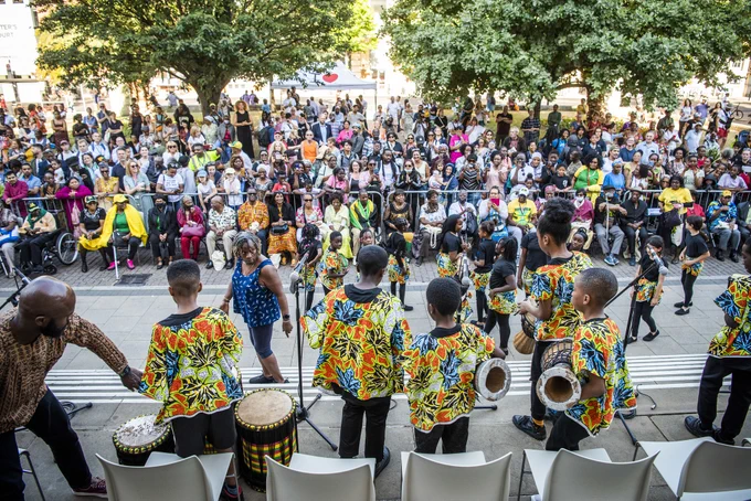Kingsmead Dynamix drumming and dance group performing in front of the big crowd outside the town hall.