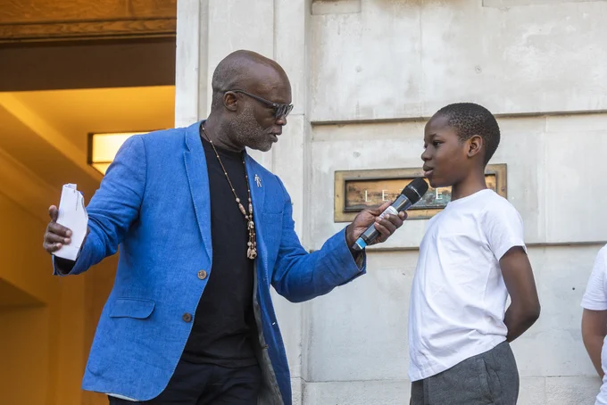 Eddie Nestor MBE chatting to one of the children from the steel pan band