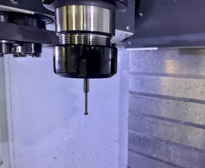 A double-angle cutter; a cutting tool larger at the bottom than at the top, which can make 90 degree chamfer cuts facing up or down.