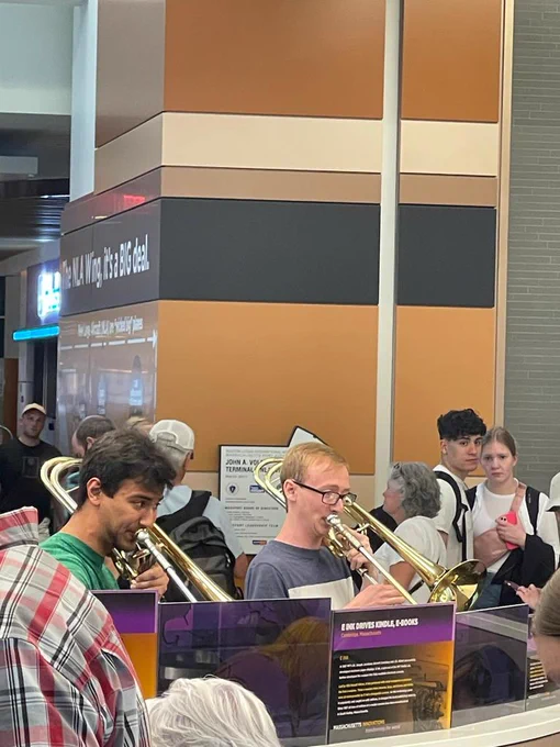 BPYO members practice while waiting for their flight at Logan Airport.