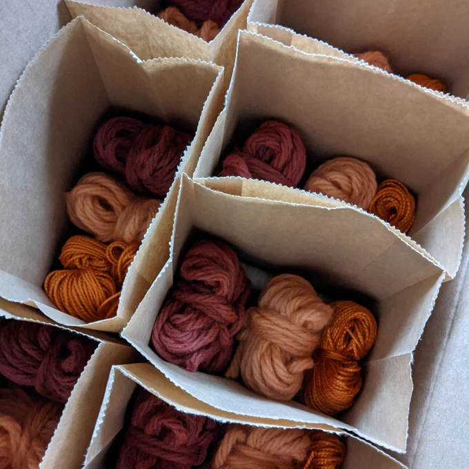 Selection of naturally dyed yarns in ochre and rust colours. 