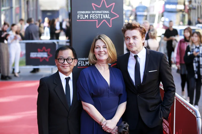 Fred Tsui, Natalie Brenner, Jack Lowden on the red carpet.