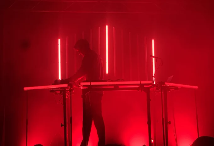 The extraordinarily talented musician, Nicolas Demuth, aka Parra for Cuva, opens the final show of his tour illuminated by glowing red neon light. Lido Club, Berlin. 14.6.22.