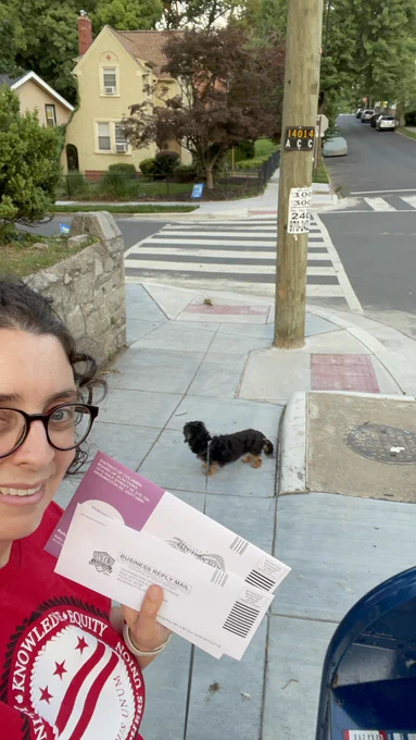 Laura Fuchs casting ballots in the mail and her dog.