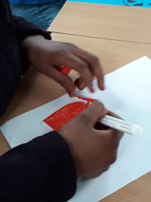Ceramic heart being coloured in red