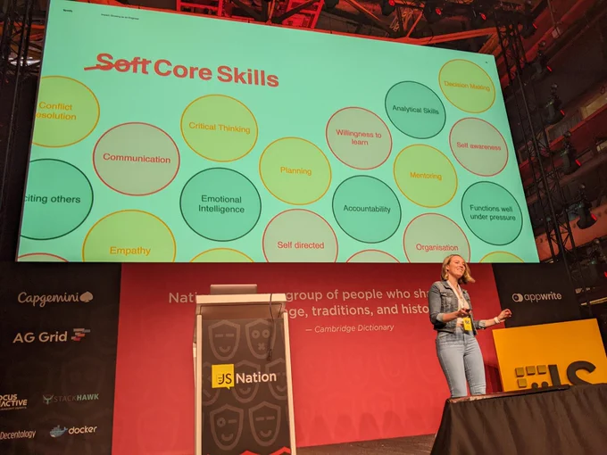 Iris speaking in front of a slide that says "Soft" (struck out) replaced by "Core Skills" with circles labeled with different skills sich as "Communication", "Critical Thinking", "Planning", "Emotional Intelligence" etc