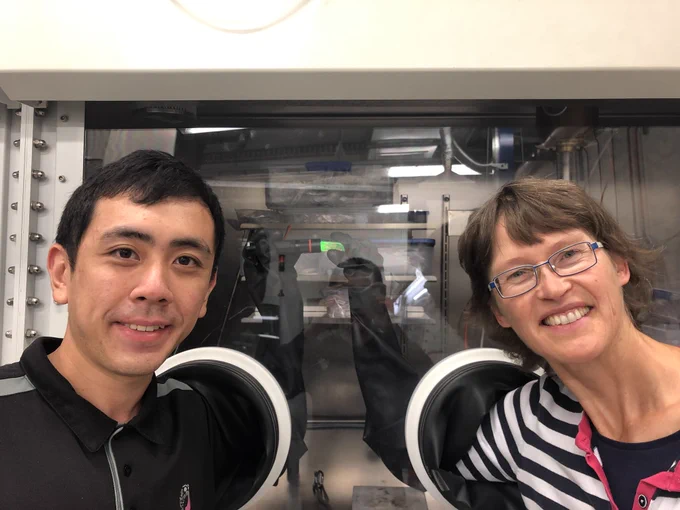 The photo shows Alson Ng (on the left), who is an expert in ZBLAN glass fabrication at the Optofab Adelaide Hub of The Australian National Fabrication Facility (ANFF). We are holding a ZBLAN glass emitting green fluorescence upon excitation with UV light.