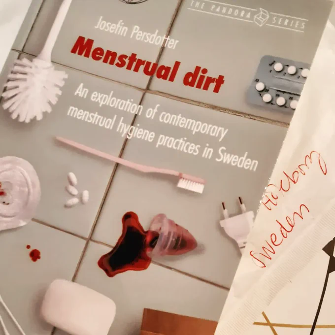 The excellent cover of Menstrual Dirt: an exploration of contemporary menstrual hygiene practices in Sweden by Josefin Persdotter, which features a toilet brush, birth control pills, a toothbrush, a cloth pad, and other bathroom accoutrements on a grey tile background. You can get this online as an open access pdf! 