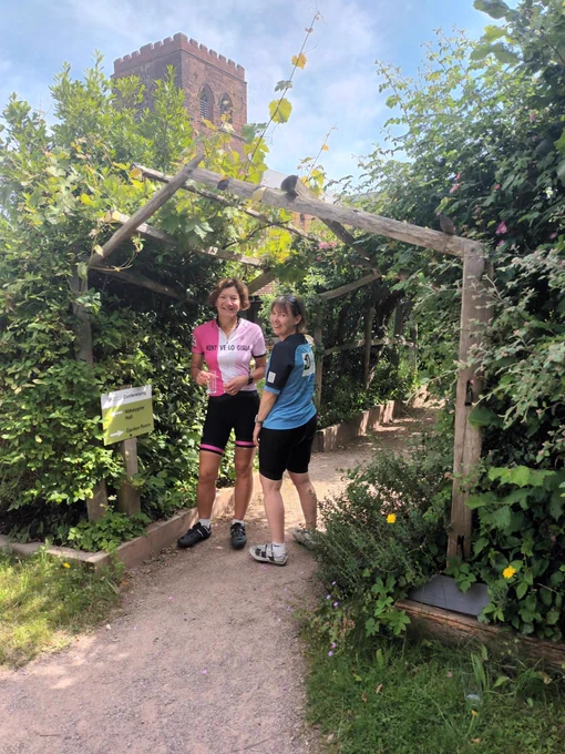 Susan and friend stood in front of a sign for the visitor centre nature reserve.