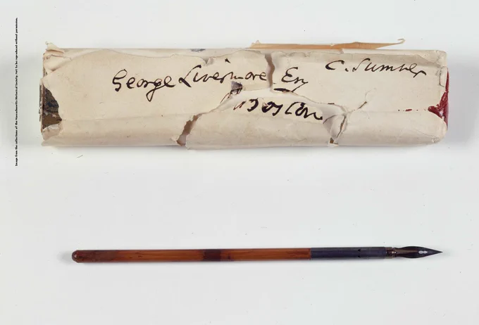 Photograph of fountain pen used by Abraham Lincoln to sign the Emancipation Proclamation. Also included in the photo is a paper wrapper that held the pen.
