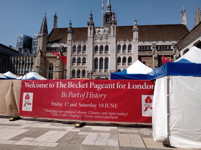 Banner promoting The Becket Pageant for London "Be Part of History", with historic building Guildhall in the background