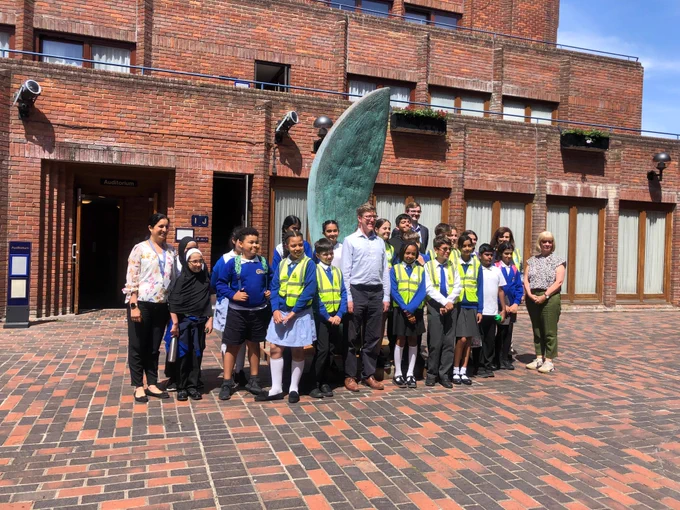 A group of Y5 and Y6 students standing in Robinson College Front Court.
