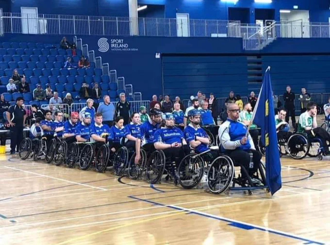 The Munster Wheelchair Hurling Camogie Club line out with Provincial Flag 