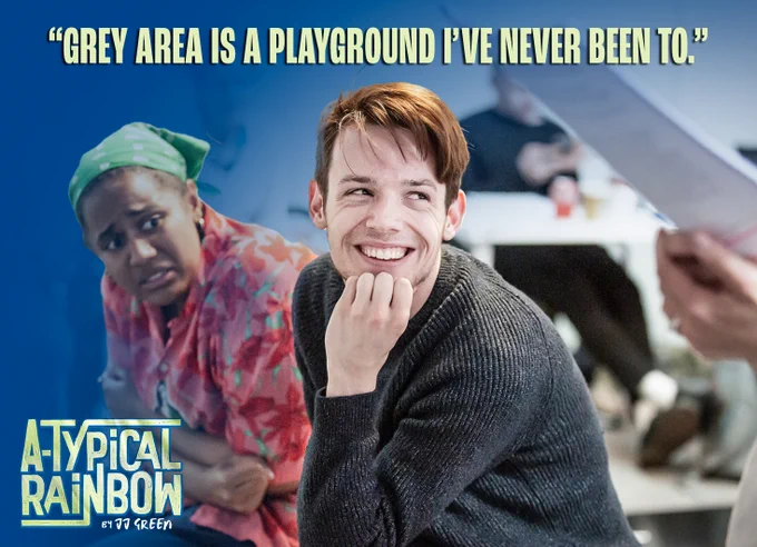 A photograph of actor JJ Green (smiling - right) and actress Maya Manuel (left) sat, with bold light green text at the top of the image saying "Grey Area is a playground I've never been to" in capitals. Bottom left is a logo for the production 'A-Typical Rainbow, by JJ Green'.