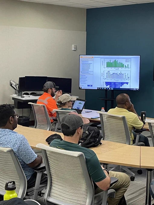Holden Smith sits among students in a classroom analyzing data. Photo by Rebecca Maloy (USGS).