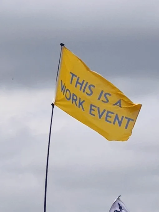 Glastonbury Flag: “this is a work event.”
