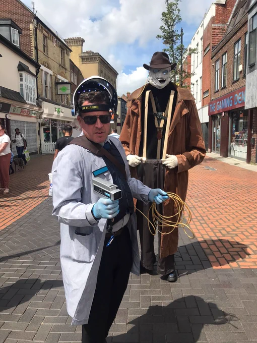 A man in a white coat infront of the invisible man.