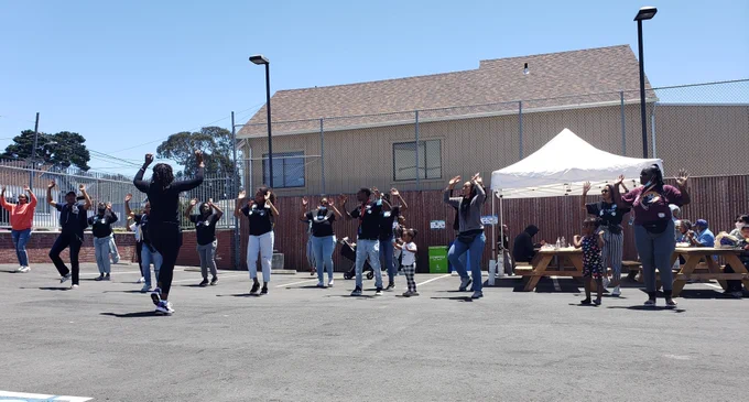 A line of people dancing