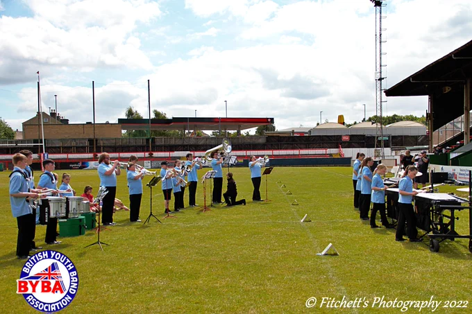 A wide shot showing the drum, brass, and tuned percussion sections of Revo Juniors