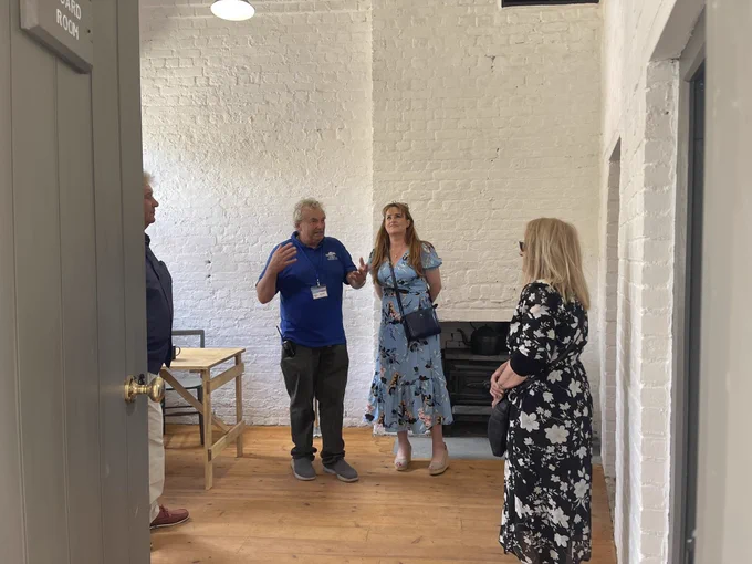 Kelly Tolhurst being shown around the Guard Room by Vice Chair of the Slough Fort Preservation Trust, Keith